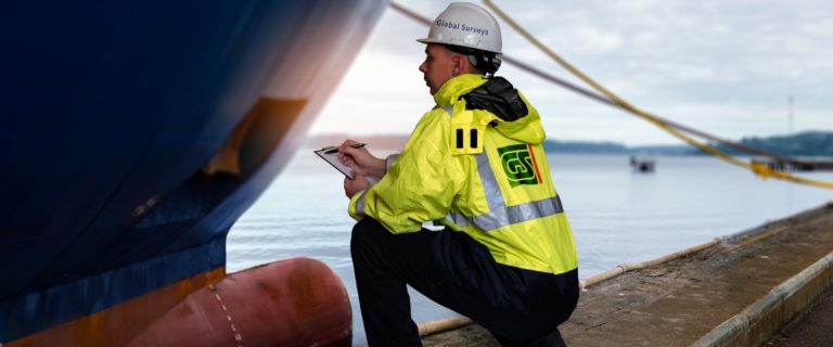 Global Surveys Inspector checking draft of a ship in sea port