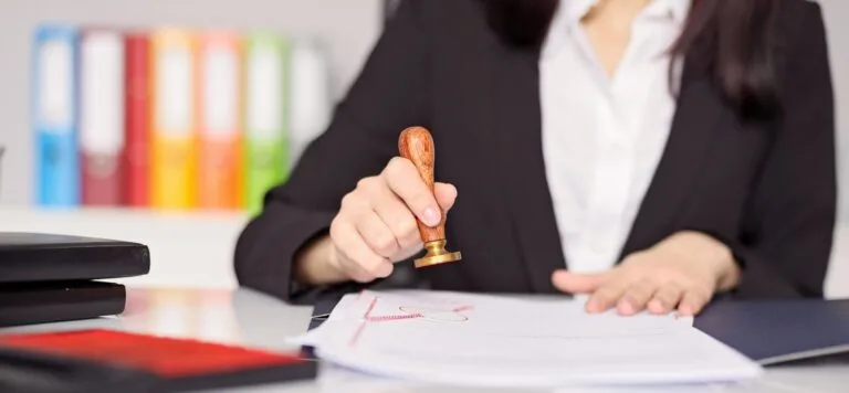 woman stamping a certificate provided by global surveys